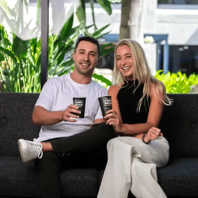 VendiBean founders, a BrandRocket client, holding branded coffee cups